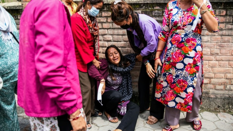 Relatives of victims waited outside a hospital in Kathmandu to receive their bodies