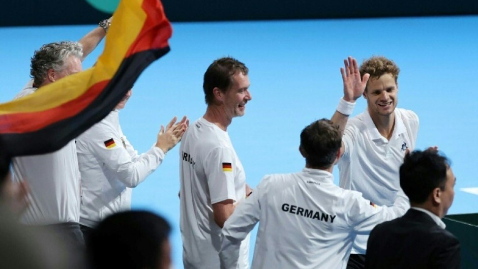 Germany's Yannick Hanfmann (top R) celebrates with teammates after his victory over Japan's Shintaro Mochizuki in Davis Cup second round qualifiers