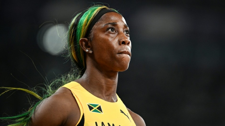 Shelly-Ann Fraser-Pryce glances at the giant screen in Tokyo after bringing down the curtain on her individual sprint career