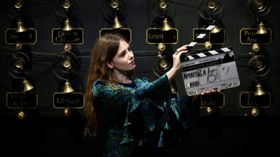 A clapper board used in the production of the film 'Downton Abbey: A New Era', in front of the 'bell wall'