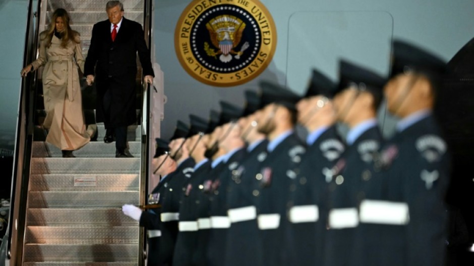 US President Donald Trump and US First Lady Melania Trump disembark from Air Force One at the start of the state visit