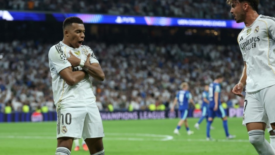 Kylian Mbappe celebrates his second penalty as Real Madrid came from behind to beat Marseille 2-1