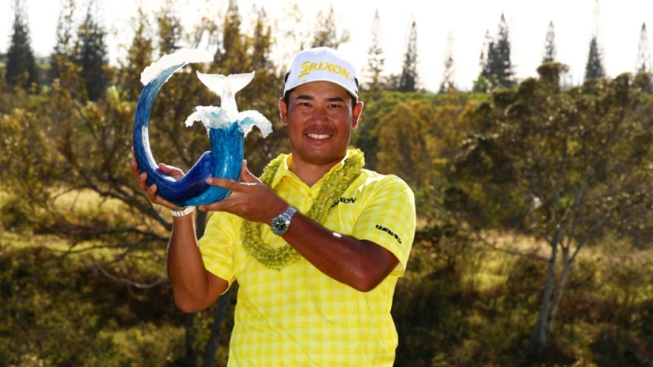 Japan's Hideki Matsuyama holds the trophy from winning the 2025 Sentry title, but the PGA Tour announced drought conditions mean the Plantation Course at Kapalua will not host the traditional season-opening event next January
