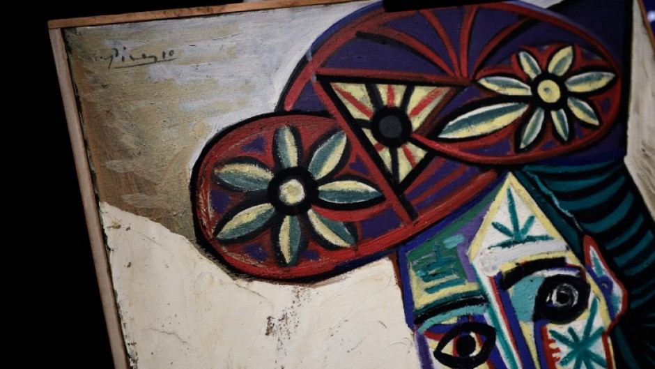 The painting is in a simple wooden frame