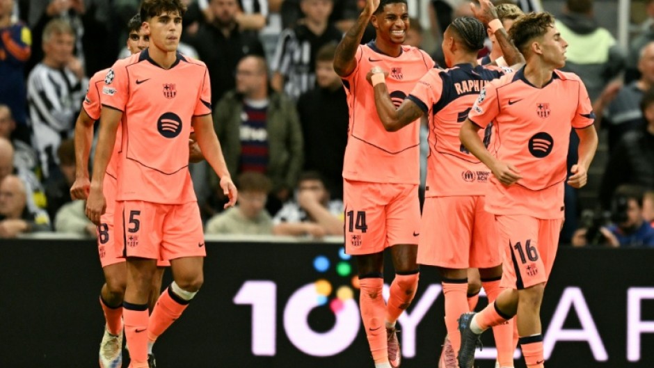 Marcus Rashford takes the acclaim of his Barcelona teammates after scoring one of his two goals against Newcastle United in the Champions League on Thursday