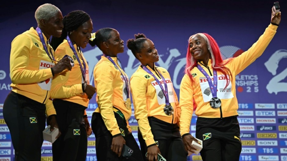 Leader of the pack: Shelly-Ann Fraser-Pryce takes one last picture with her sprint relay teammates