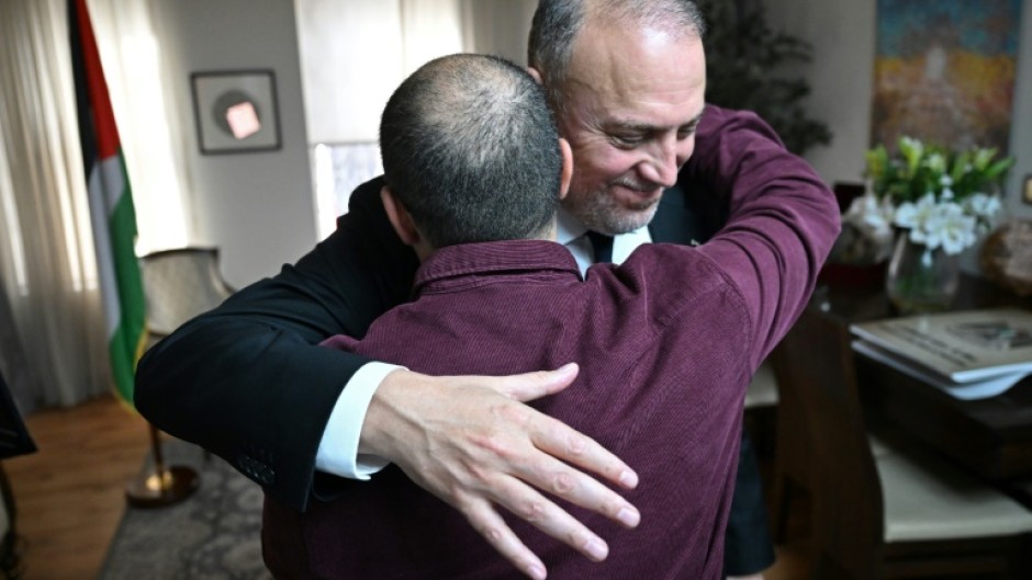 Husam Zomlot embraces a member of staff after Britain's Prime Minister Keir Starmer formally recognised a Palestinian state