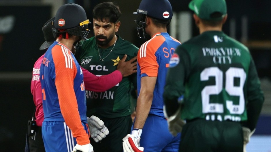 Pakistan's Haris Rauf (3R) shares words with India's Abhishek Sharma (L) during his side's Super Four loss to India on September 21