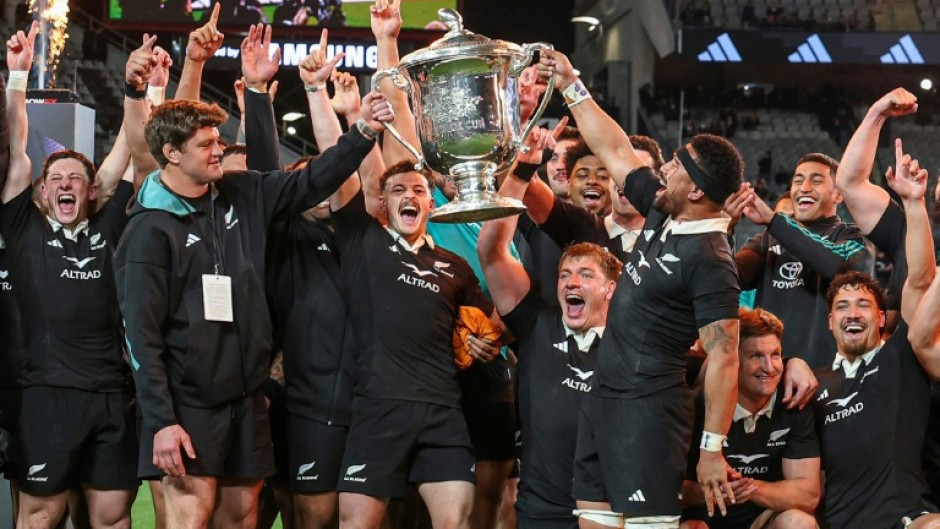New Zealand celebrate with the Bledisloe Cup after beating Australia at Eden Park in Auckland