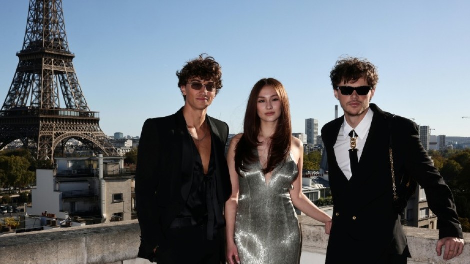 Lead actor Lola Tung (C) poses with co-stars Christopher Briney (R) and Gavin Casalegno (L)