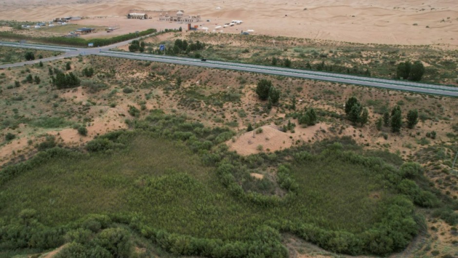 The green zone and the desert landscape in the Kubuqi Desert, in China's northern Inner Mongolia region