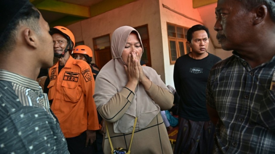 Relatives of missing students gather as search and rescue operations continue at a boarding school in East Java