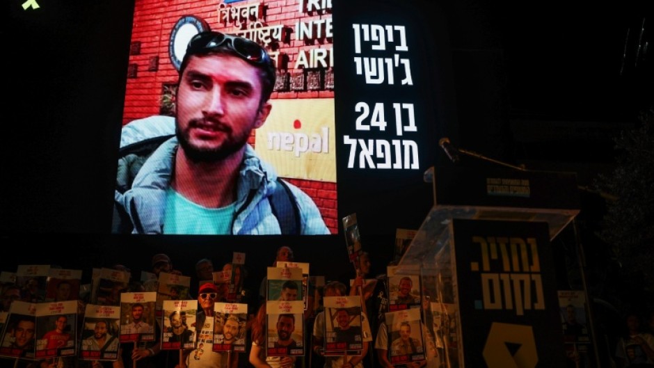 A picture of Nepalese national Bipin Joshi held hostage by Palestinian militants in Gaza since 2023, is displayed on a screen during a demonstration organised by the families of hostages calling for action to secure their release in Tel Aviv on August 16, 2025