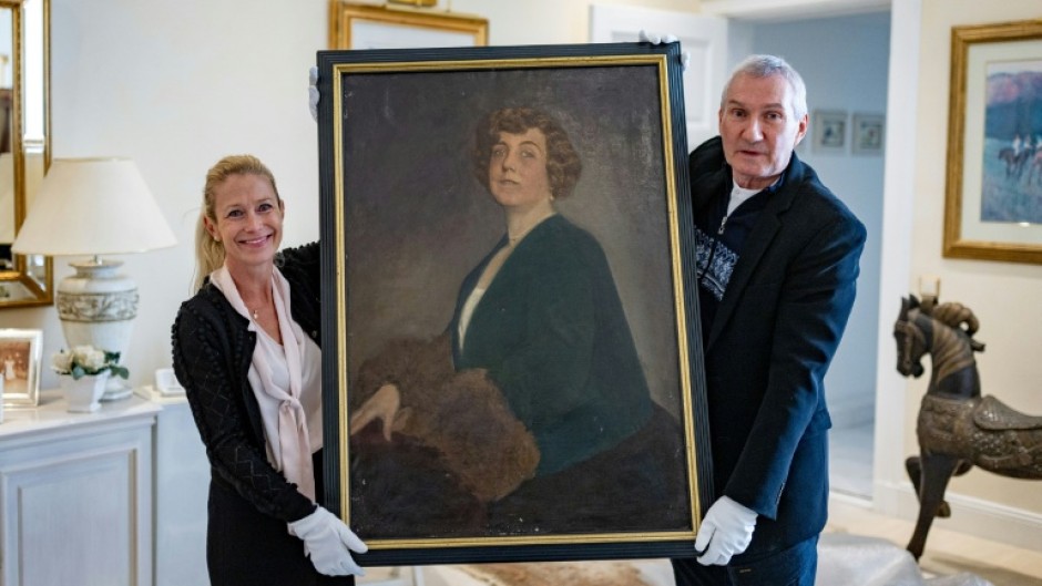 The long-lost oil painting of Madam Kitty Schmidt, shown by authors Urs Brunner and Julia Schrammel