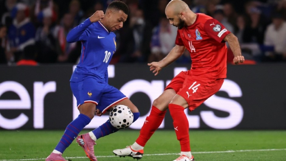 France forward Kylian Mbappe (L) and Azerbaijan defender Elvin Badalov (R) fight for the ball during the FIFA World Cup 2026 Group D qualifier at the Parc des Princes