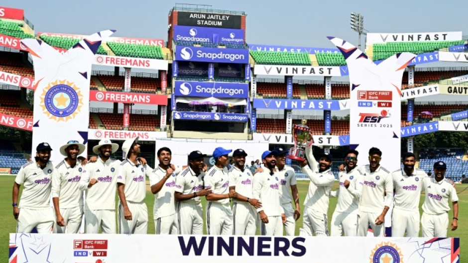 India's players celebrate with the trophy after their win against West Indies