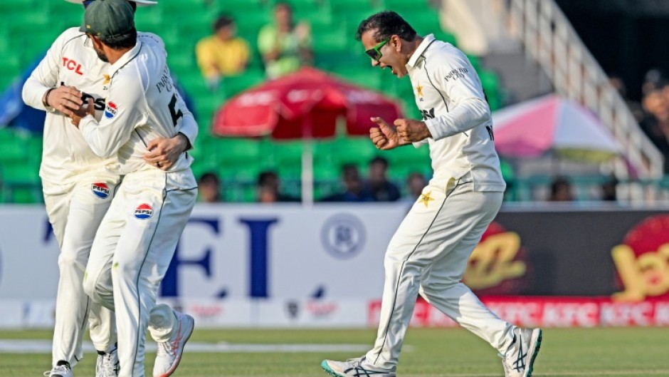 Pakistan's Noman Ali (R) celebrates after taking the wicket of South Africa's captain Aiden Markram on day three