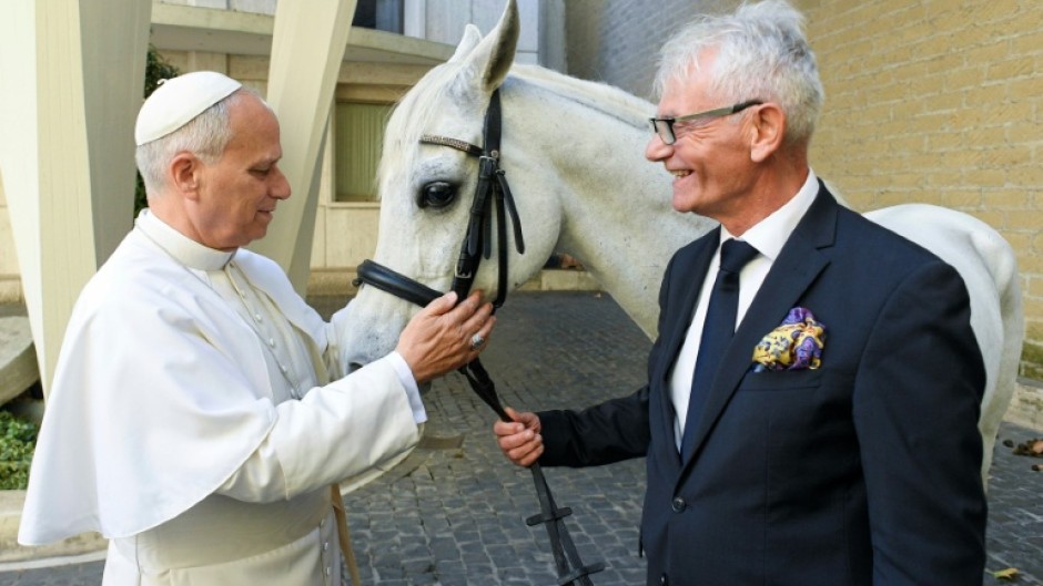A picture released by the Vatican on Wednesday showing Pope Leo XIV receiving Proton, a purebred Arabian horse