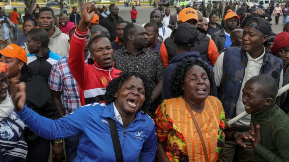 Supporters and mourners of Kenyan opposition leader Raila Odinga react at the Jomo Kenyatta International Airport (JKIA) in Nairobi