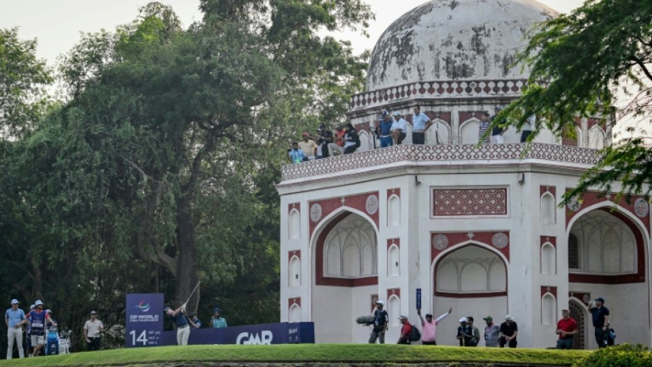 Rory McIlroy tees off beside a Mughal-era heritage monument during the DP World India Championship at the Delhi Golf Club