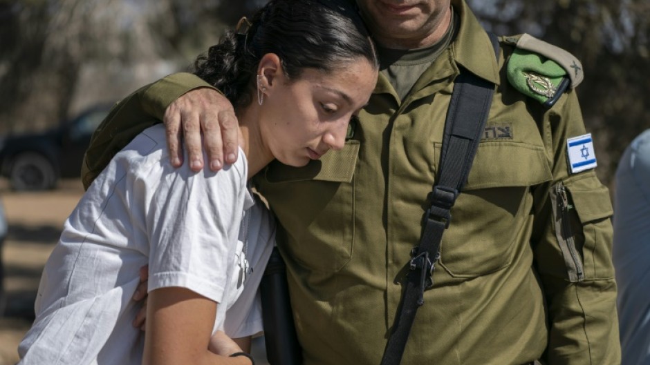 An Israeli soldier comforts a woman during a memorial service Thursday for those killed in the October 7, 2023 attacks