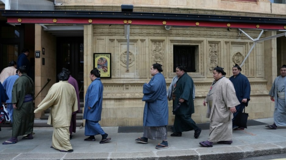 Rikishi, or sumo wrestlers, arrive at London's Royal Albert Hall ahead of the Grand Sumo Tournament