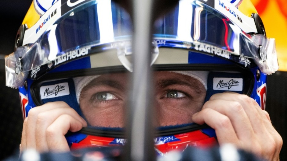 Red Bull Racing's Dutch driver Max Verstappen secures his helmet during practice for the United States Formula One Grand Prix at the Circuit of the Americas in Austin, Texas