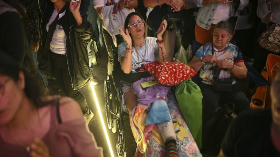 Catholics gather at La Candelaria Square to attend the canonization ceremony of Venezuelan doctor Jose Gregorio Hernandez and Venezuelan Sister Maria Rendiles in Caracas