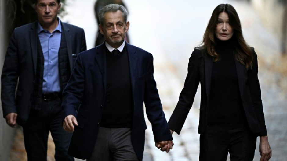 Sarkozy walked out of his home hand-in-hand with his wife singer Carla Bruni