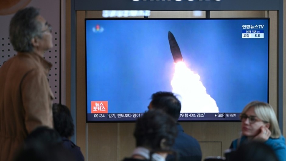 People at a train station in Seoul watch footage of a North Korean missile test