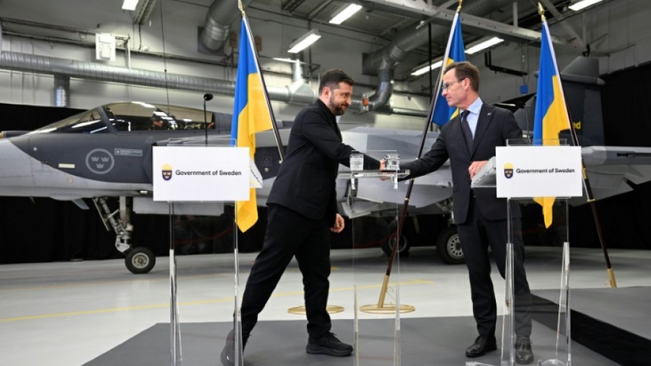 Ukrainian President Volodymyr Zelensky signs a letter of intent with Swedish Prime Minister Ulf Kristersson to get 150 Gripen fighter jets