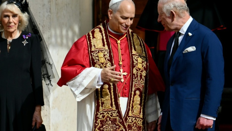 Pope Leo XIV shakes hands with Britain's King Charles III and Queen Camilla in San Damaso courtyard during their state visit to the Vatican
