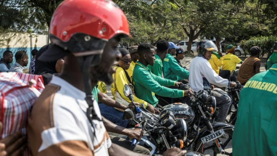 Lorries, buses and motorbikes packed with supporters weaved through town to see the leader