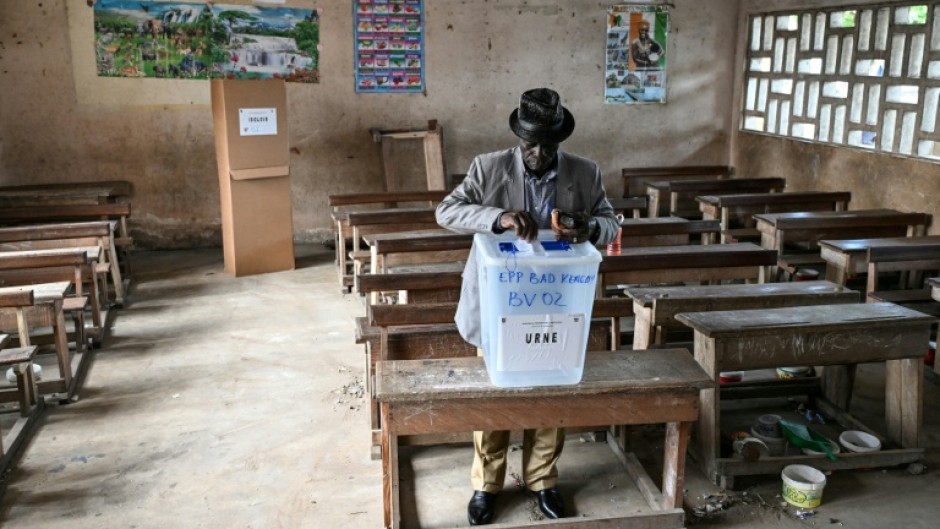 A voter casting his ballot at a polling station in Abidjan