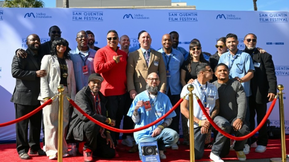 Prison warden Chance Andes (top C) poses on the red carpet with guests and inmates during the San Quentin Film Festival