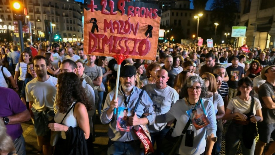 Demonstrators, many carrying photos of the victims, called for regional leader Carlos Mazon to resign