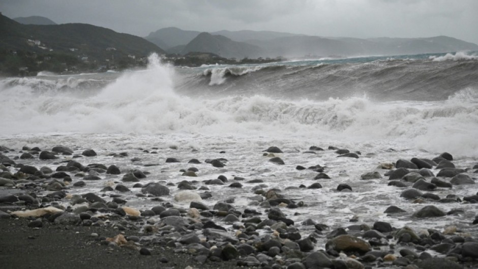Waves crash onto the beach in Kingston on October 27, 2025; Hurricane Melissa threatened Jamaica with potentially deadly rains after rapidly intensifying into a top-level Category 5 storm