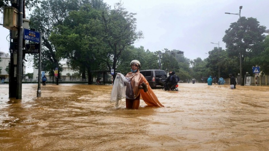 Flooding triggered by record heavy rain has killed at least four people and inundated more than 100,000 homes in central Vietnam, the environment ministry said