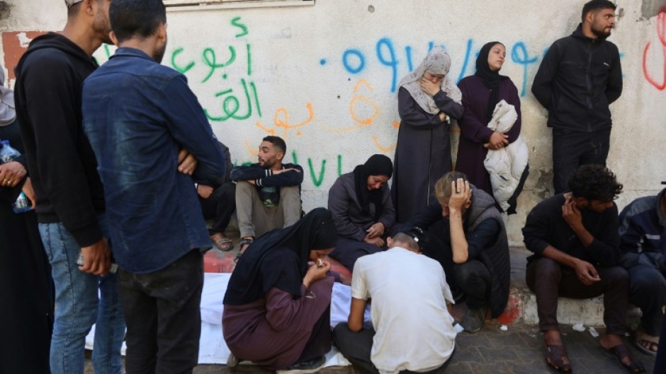 Palestinians mourn over the body of a relative who was killed in overnight Israeli strikes