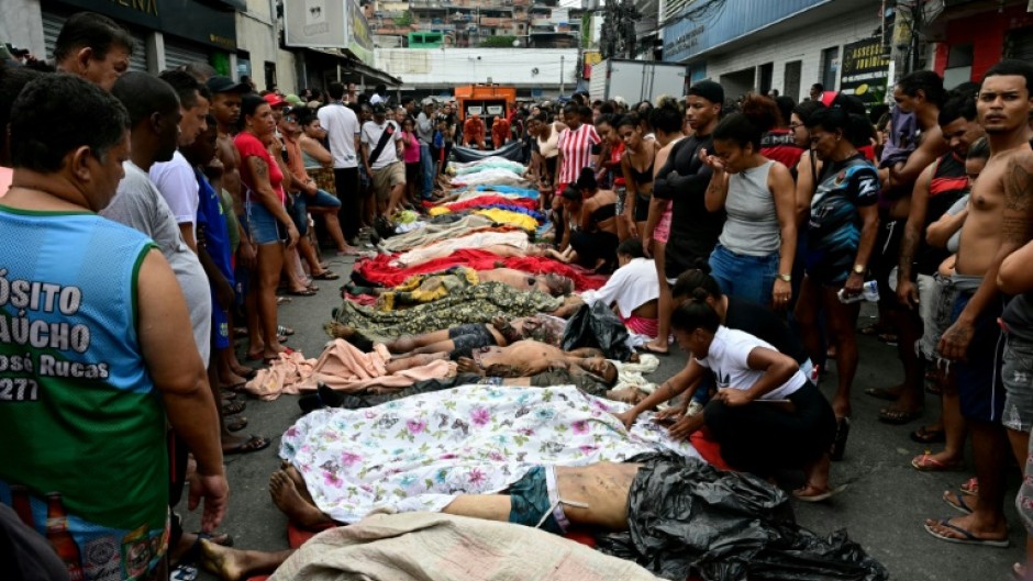 People line up bodies on Sao Lucas Square of the Vila Cruzeiro favela at the Penha complex in Rio de Janeiro, Brazil, on October 29, 2025, in the aftermath of Operacao Contencao (Operation Containment). Residents of a favela in Rio de Janeiro lined up more than 50 bodies at a plaza in their low-income neighborhood on Ocotber 29, a day after the bloodiest police operation in the city's history, AFP reported.