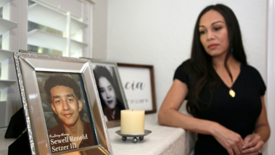 Megan Garcia stands next to a picture of her late son, Sewell Setzer III. The 14-year-old had fallen in love with a 'Game of Thrones' -inspired chatbot from Character.AI