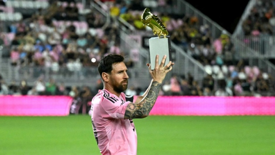 Lionel Messi poses with the MLS Golden Boot trophy after scoring 29 times in 28 games in the regular season