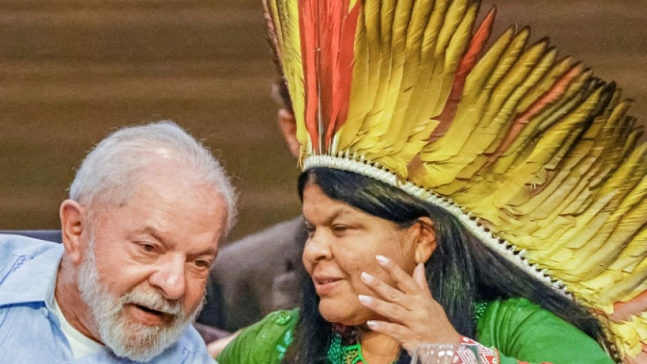 Brazilian President Luiz Inacio Lula da Silva (L) and his Minister of Indigenous Peoples, Sonia Guajajara, chat during a meeting in Belem