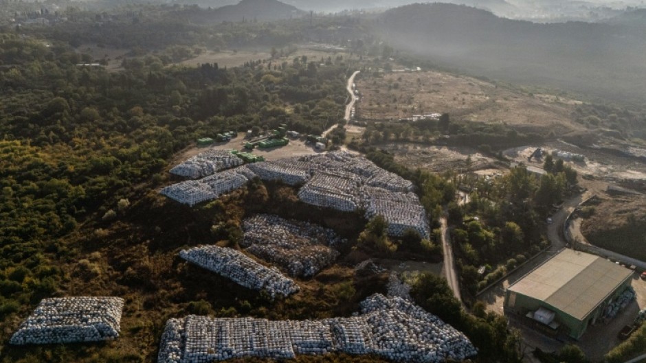 Plastic-wrapped waste bales stored outside a recycling plant on the Greek island of Corfu, part of a groundbreaking waste-management programme
