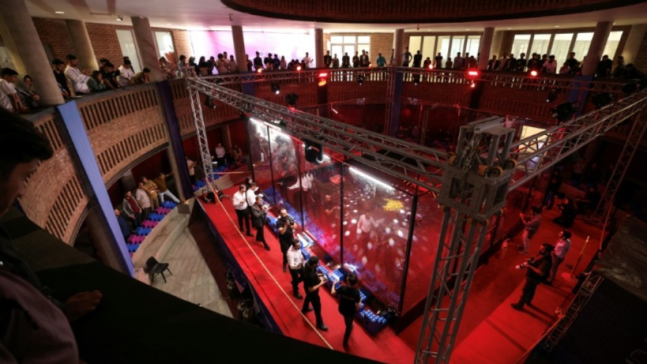 Engineering students and guests watch robots battle it out at Iran's Tech Olympics