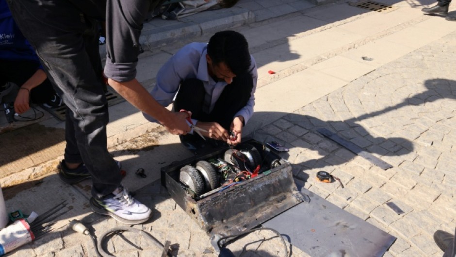 Engineering students prepare their robot for a battle event at Iran's Tech Olympics