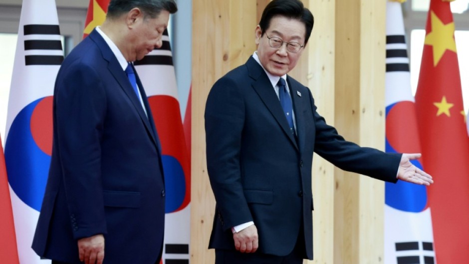 President Lee Jae Myung (R) is hosting Xi Jinping on the Chinese leader's first visit to South Korea in more than a decade