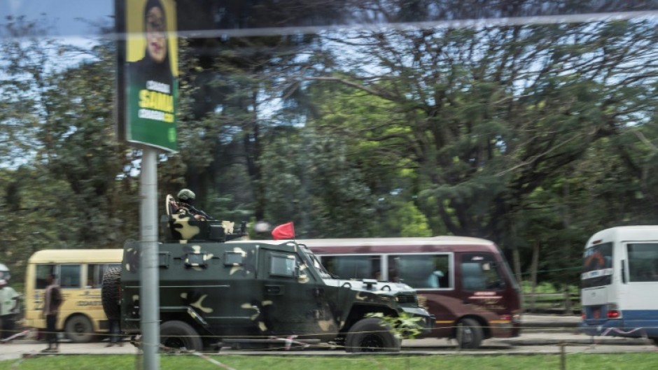 Soldiers in Zanzibar drive past posters of President Samia Suluhu Hassan