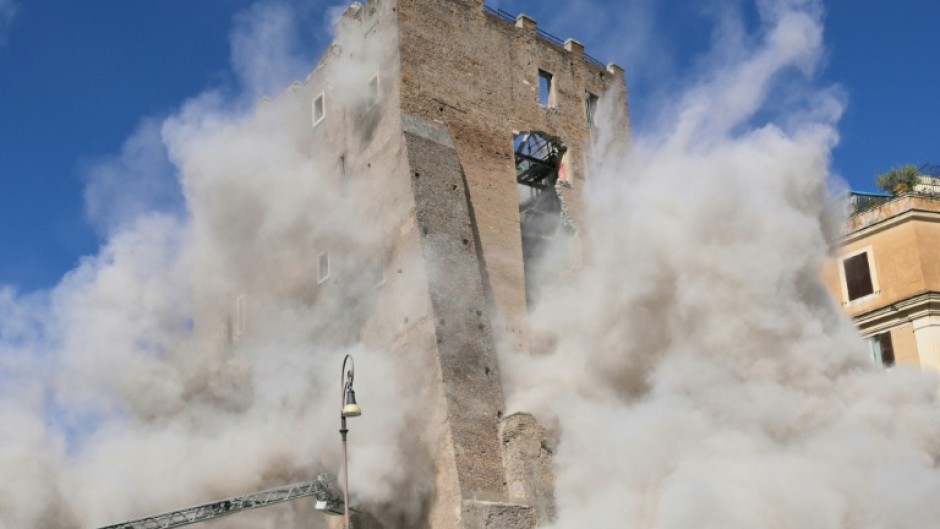 Dust rises after the collapse of part of the medieval Torre dei Conti tower in Rome