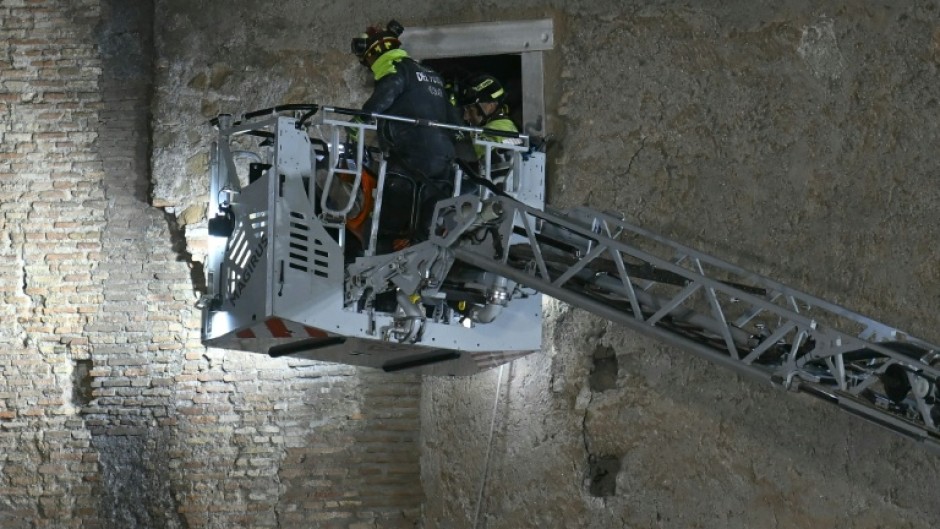 Rescuers worked to evacuate a worker who was trapped in the medieval tower Torre dei Conti after the tower partially collapsed in the historic center of Rome